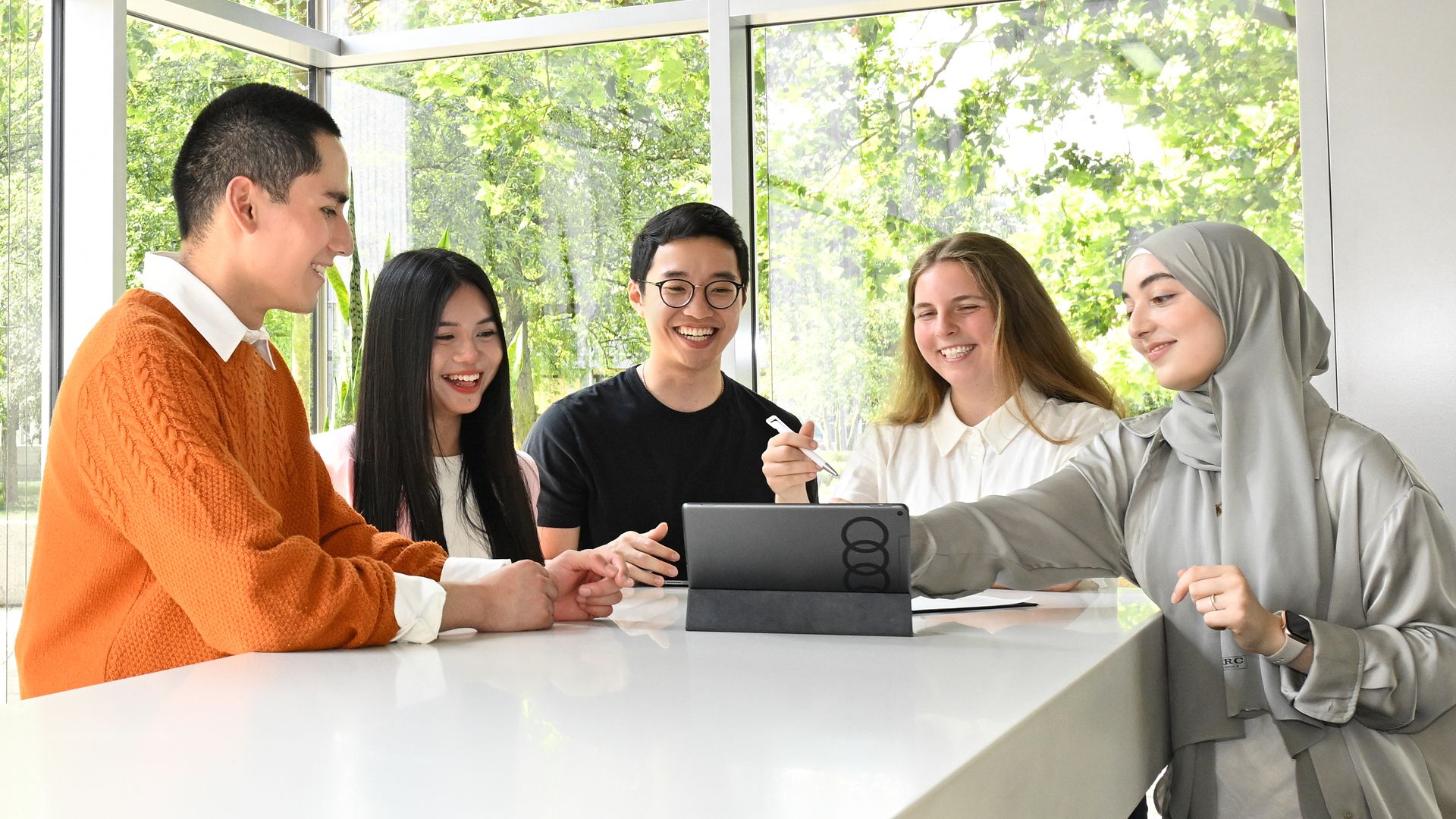 Five Audi employees are looking on an IPad together