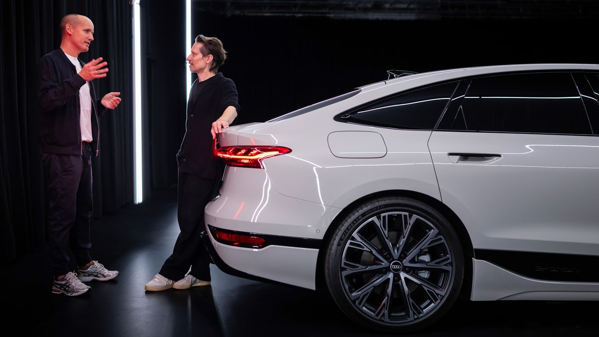 Wolf Seebers and Sascha Heyde stand next to an Audi A6 e-tron