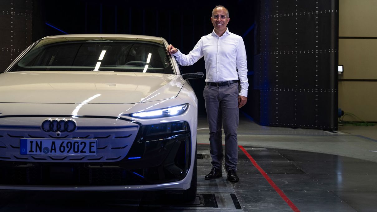 Moni Islam stands next to the Audi A6 e-tron