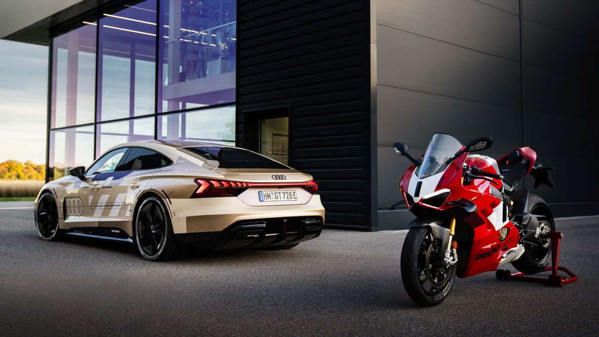 Rear view of the Audi e-tron GT next to the Ducati Panigale V4 R