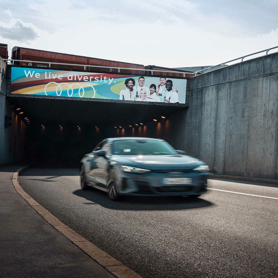 An Audi model drives out of a tunnel